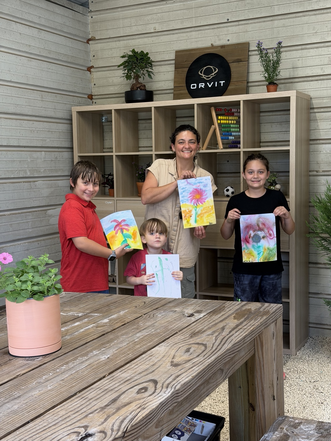ORVIT students and their instructor holding their first watercolor nature-journal paintings