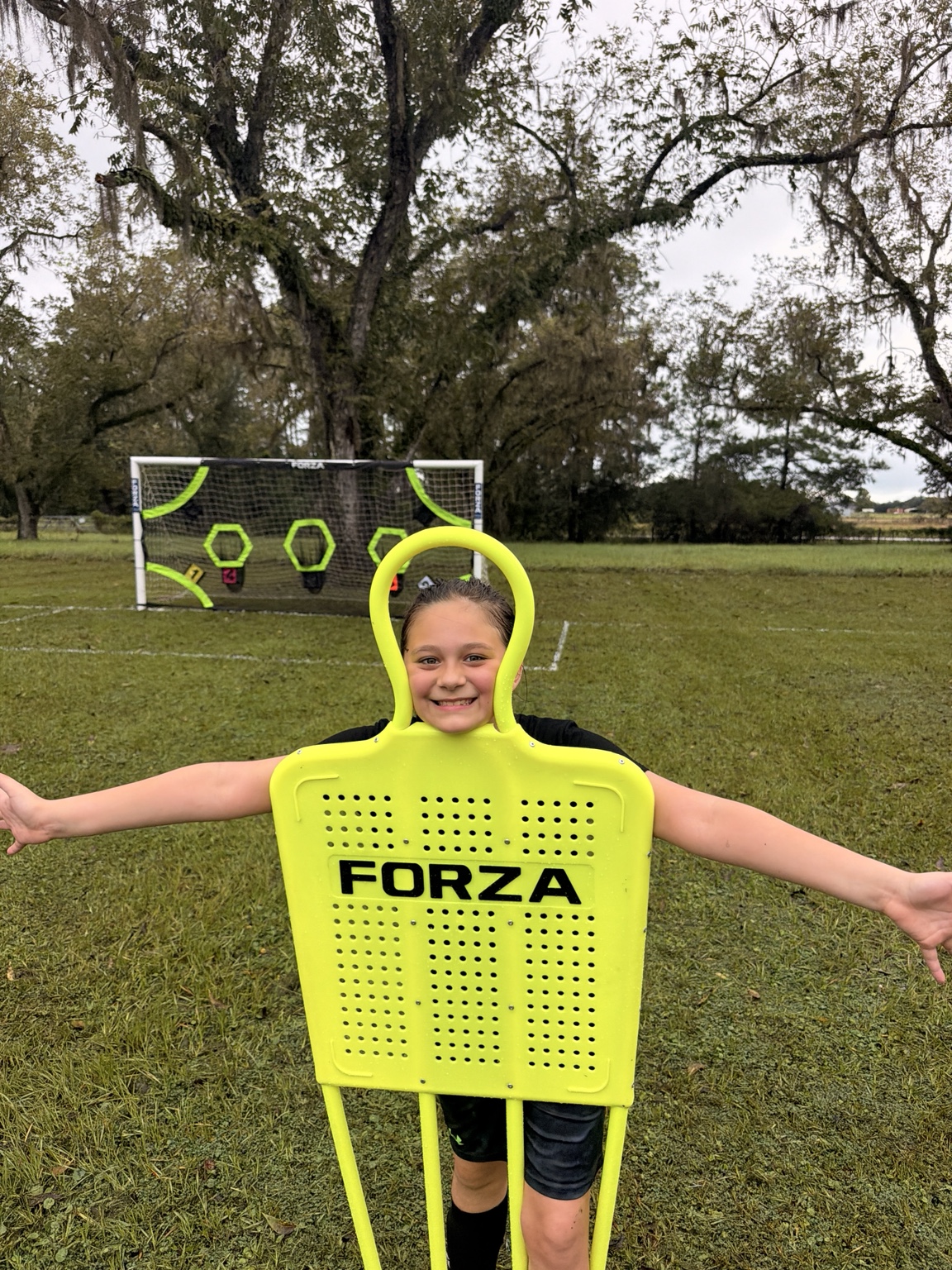 A smiling ORVIT student on the wet soccer field during the first Discovery Lab